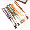 Pack de 7 Tasbihs de colores variados (rojo, azul, verde, amarillo, etc.) sobre tela de oración